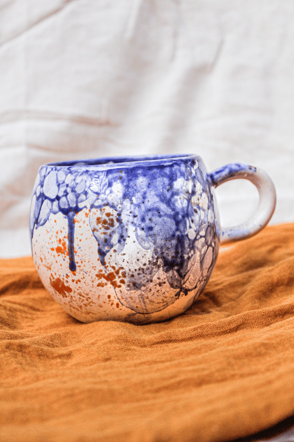 fotografía de producto de taza cerámica pompas azules